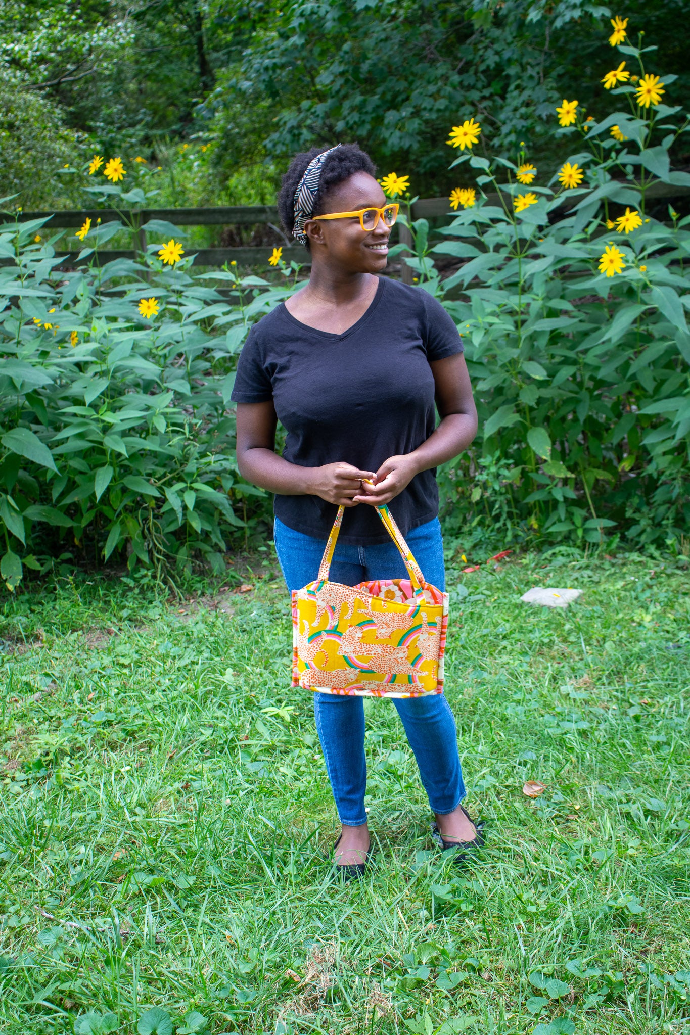 Image of yellow floral Rivet Patterns Wave Top Tote being held