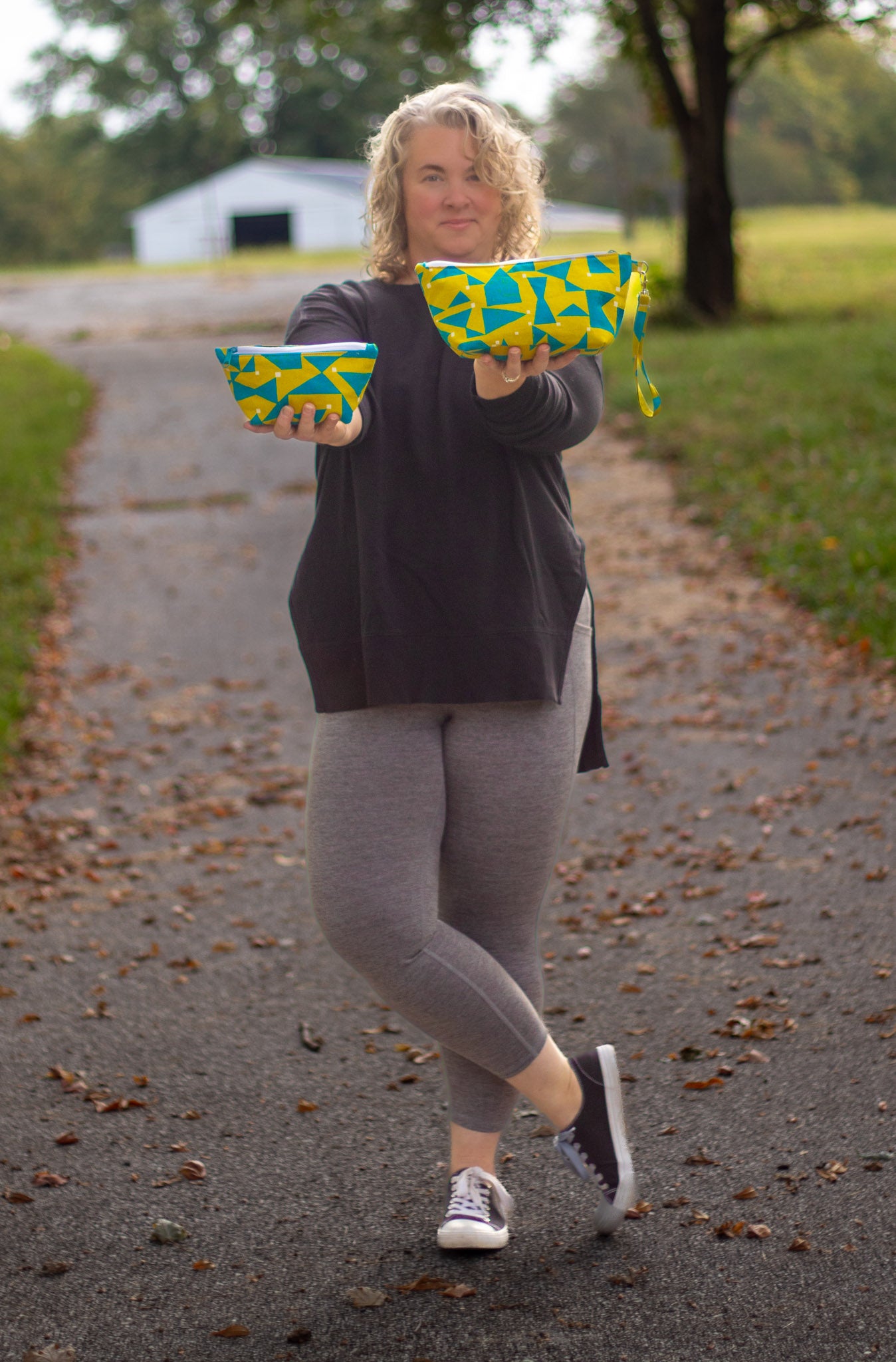 Image of yellow and blue Rivet Patterns Prelude Pouch being held