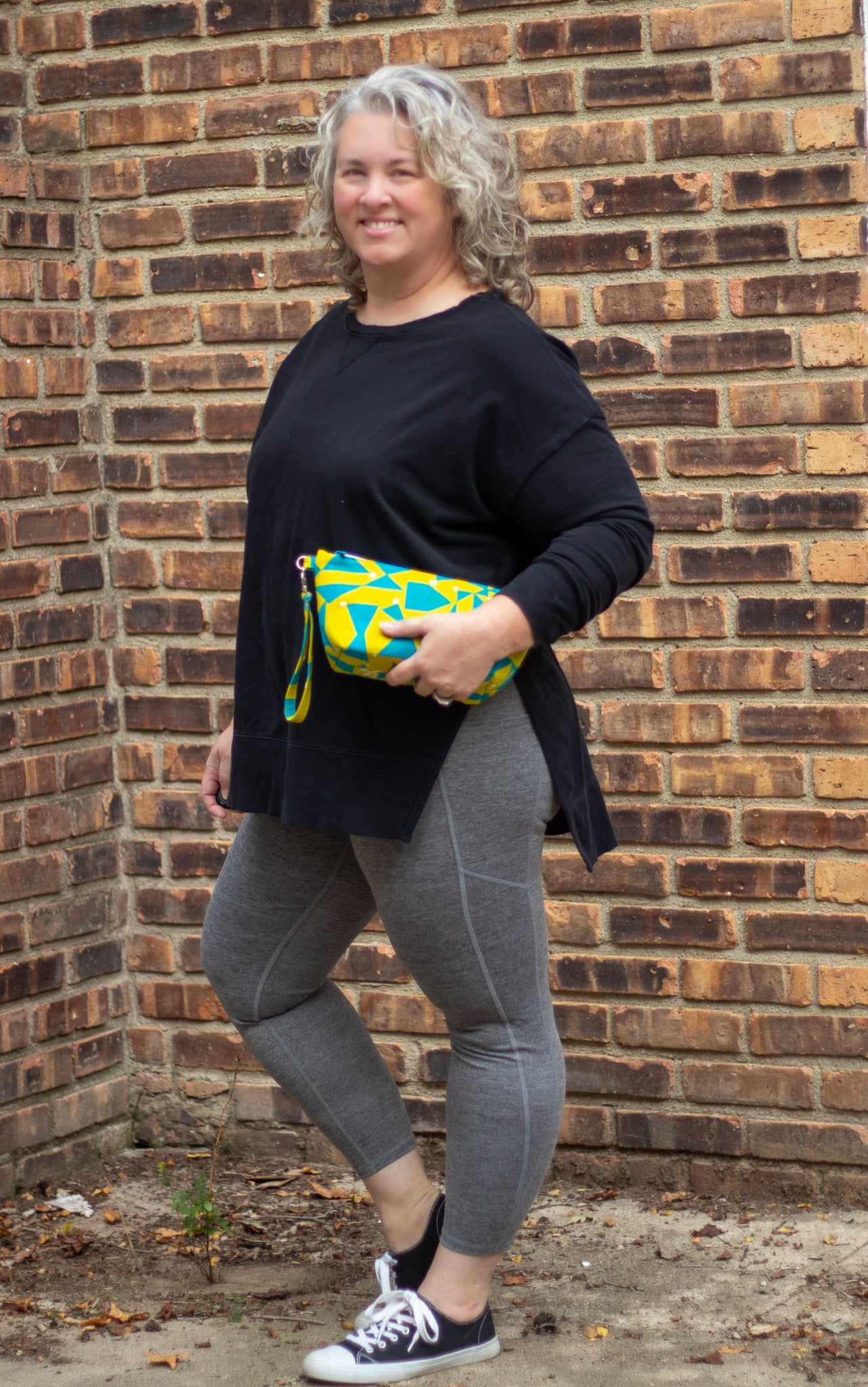 Image of yellow and blue Rivet Patterns Prelude Pouch being held